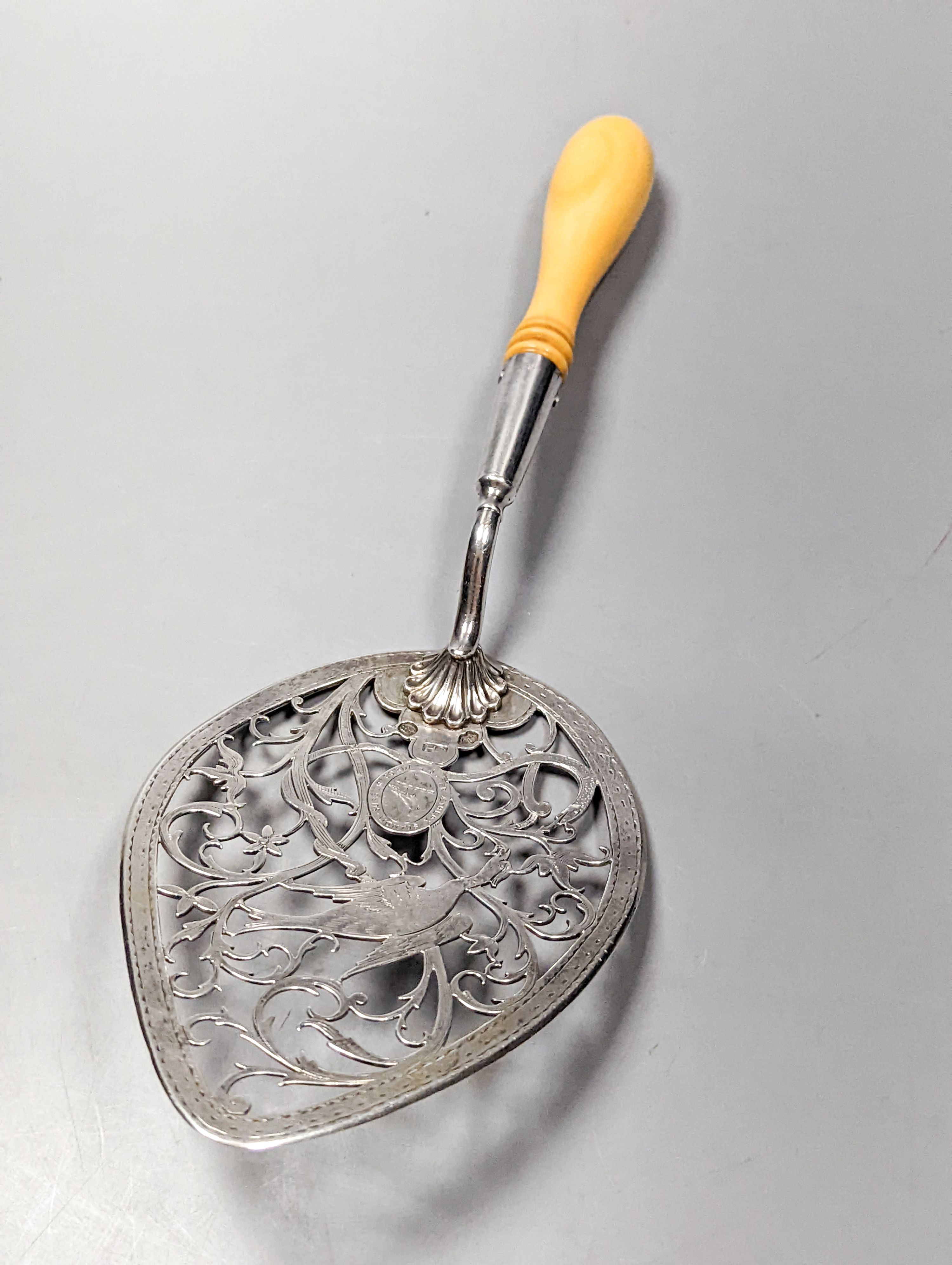 A George III Irish ivory handled pierced silver cake slice, Christopher Haines, Dublin, circa, 1790, 29.1cm, gross 4.5oz.